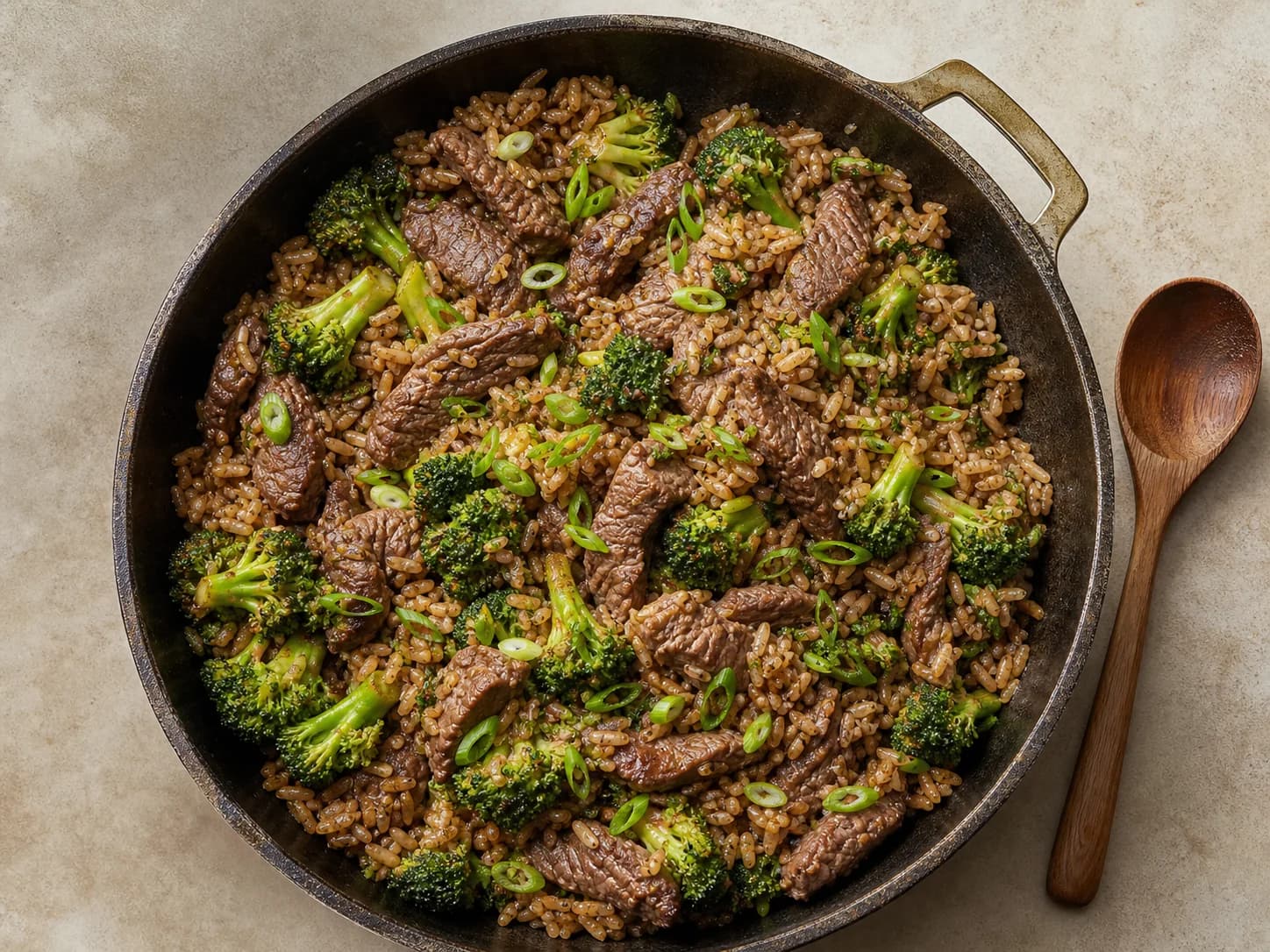 Overhead view of beef & broccoli rice skillet, served as a family dinner.