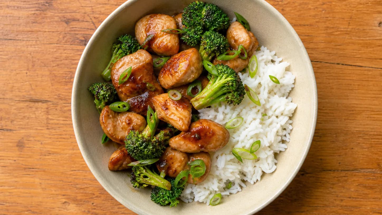 Honey-tamari chicken and broccoli beside jasmine rice with sliced scallions.