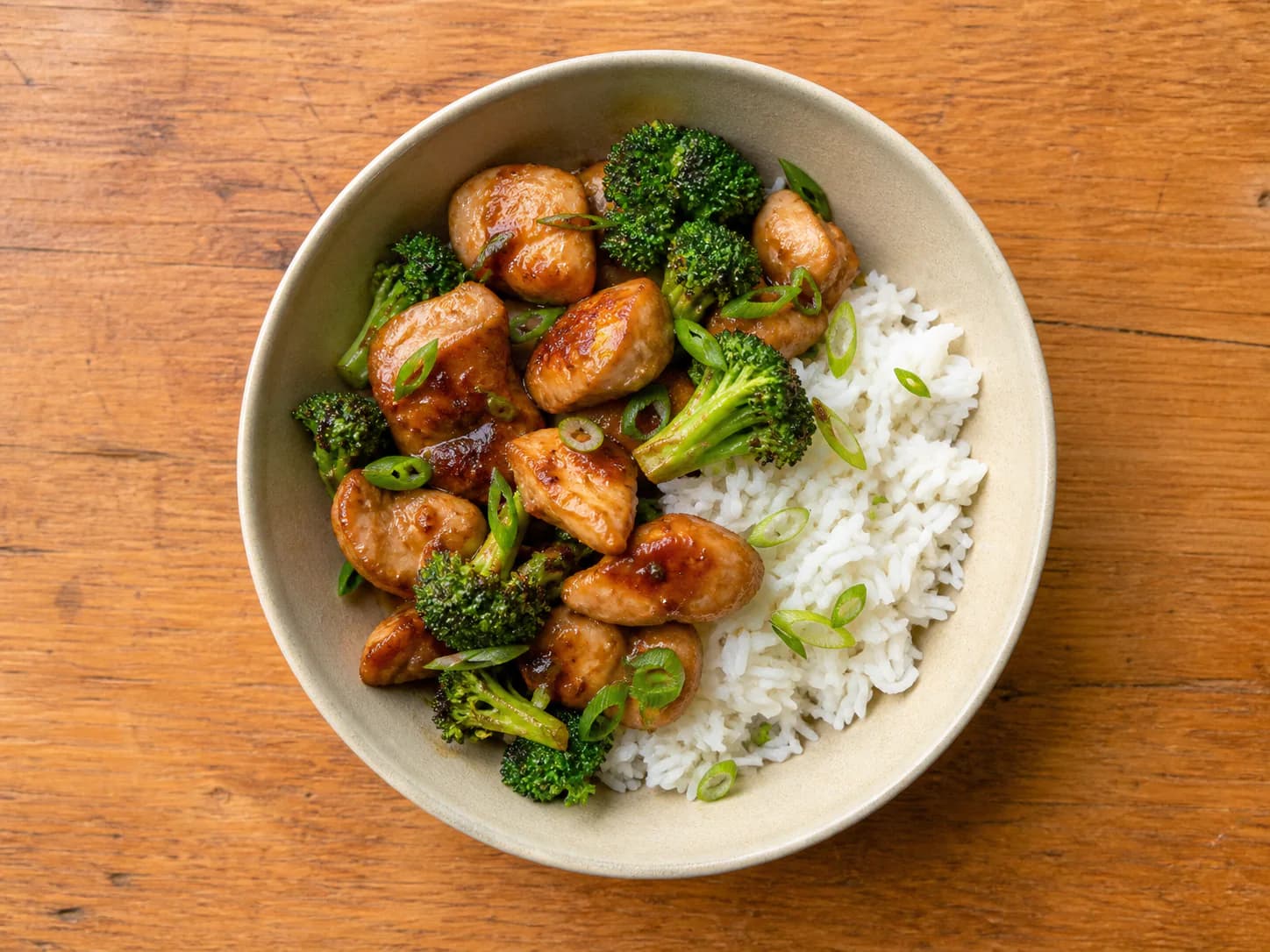 Honey-tamari chicken and broccoli beside jasmine rice with sliced scallions.