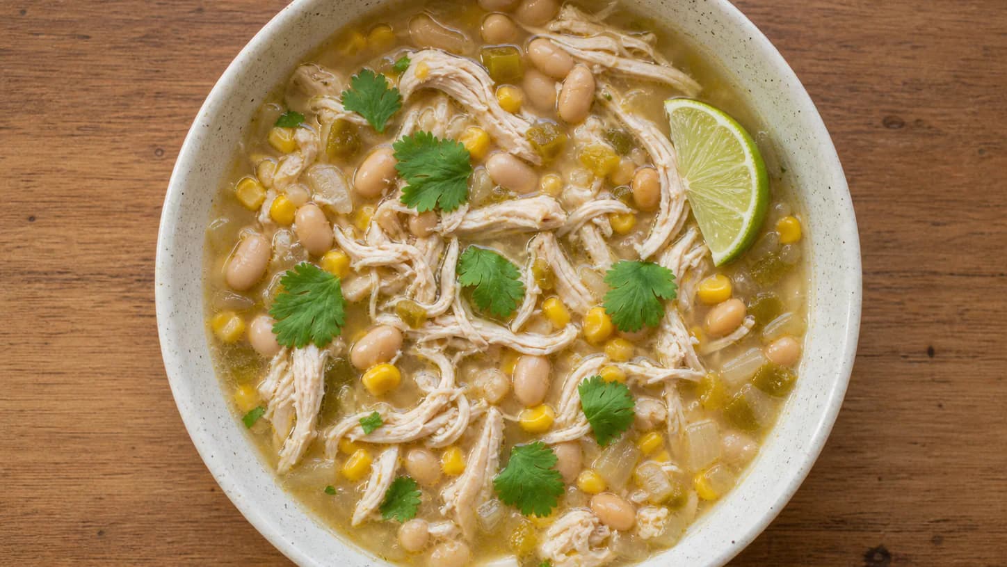 White chicken chili with shredded chicken, white beans, corn, mild green chiles, cilantro and lime.