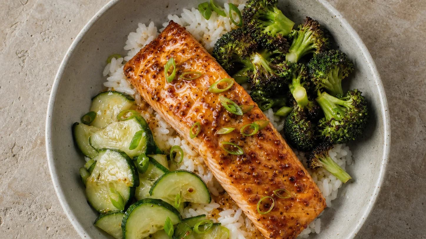 Overhead view of maple-mustard salmon rice bowls, served as a family dinner.
